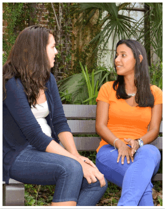 two young women sitting on a bench