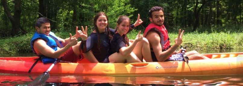 young people in canoe on river