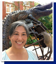 smiling woman and gator statue